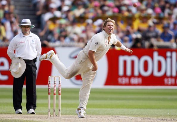 Australian spinner Shane Warne (R) sends