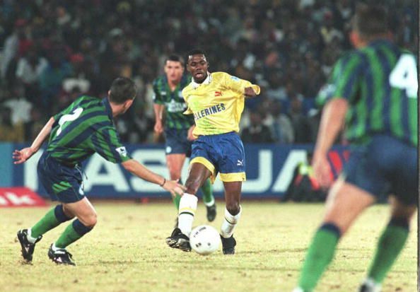 Sundowns striker Russell Molefe (C) dribbles Leeds