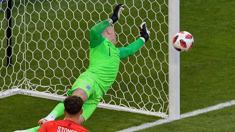 Jordan Pickford tips a Sweden effort around the post.