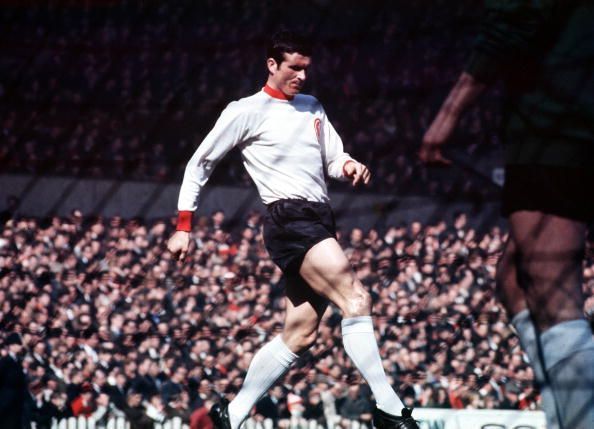 Liverpool&#039;s defender Ron Yeats in action, seen through the net.