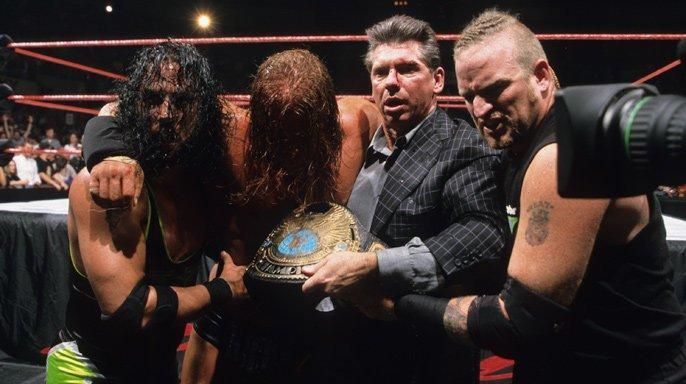 Triple H is carried away after the match against Rock