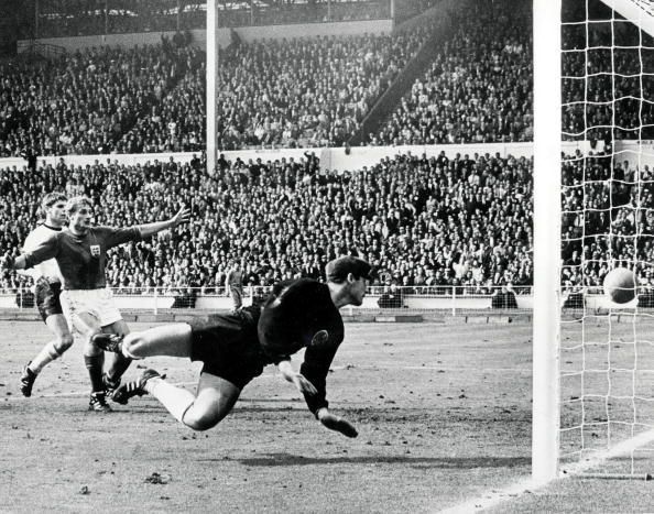 World Cup Final, 1966. 30th July, 1966. Wembley Stadium, England. England 4 v West Germany 2. England&#039;s controversial third goal scored by Geoff Hurst in the first half of extra time. German goalkeeper Hans Tilkowski dives for the ball after it had hit th