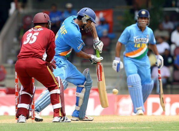 Indian batsman Mohammad Kaif (C) slams a