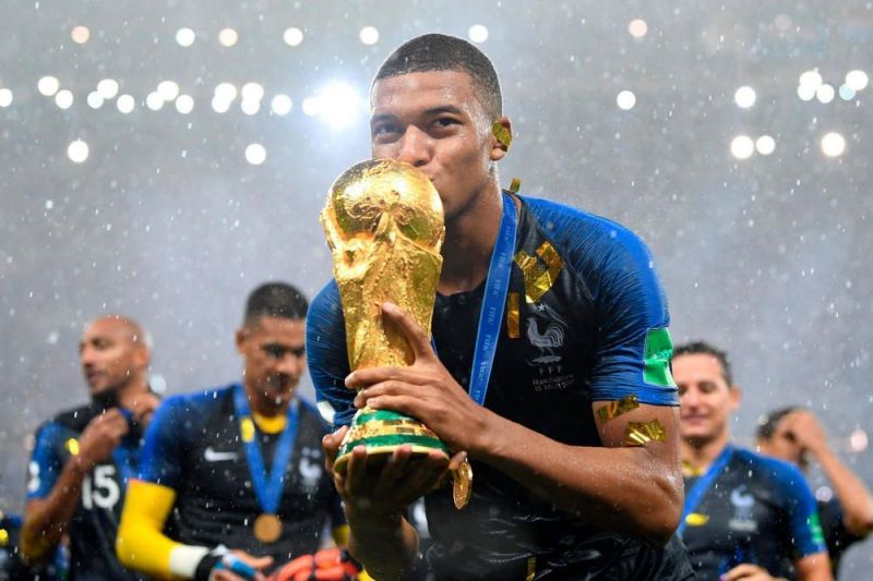 The French Golden Boy Kylian Mbappe posing with the 2018 World Cup trophy
