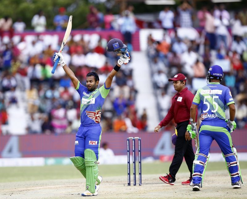 Kaushik Gandhi celebrates after reaching his century