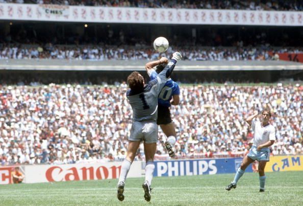 1986 World Cup Quarter Final, Azteca Stadium, Mexico, 22nd June, 1986, Argentina 2 v England 1, Argentina&#039;s Diego Maradona scores his side&#039;s first goal past English goalkeeper Peter Shilton by use of his hand, Maradona later claimed that the goal was scor