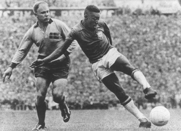 1958 World Cup Final. Stockholm, Sweden. 29th June, 1958. Sweden 2 v Brazil 5. Brazil&#039;s Pele shoots as he is challenged by a Swedish defender.