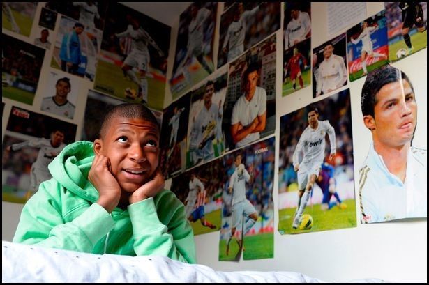 13-year-old Mbappe pictured in his bedroom surrounded by a Cristiano Ronaldo shrine