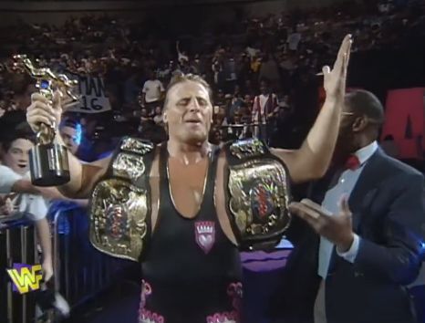 Why is Owen Hart holding both title belts?