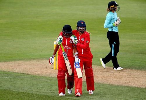 Harmanpreet and Sophie Ecclestone share a huddle after the former's heroics in yesterday's game