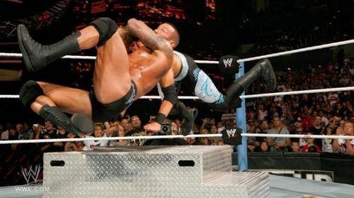 Randy Orton RKOs Christian on top of steel steps