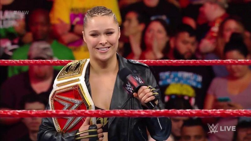 Ronda Rousey with the RAW Women's Championship on her shoulder