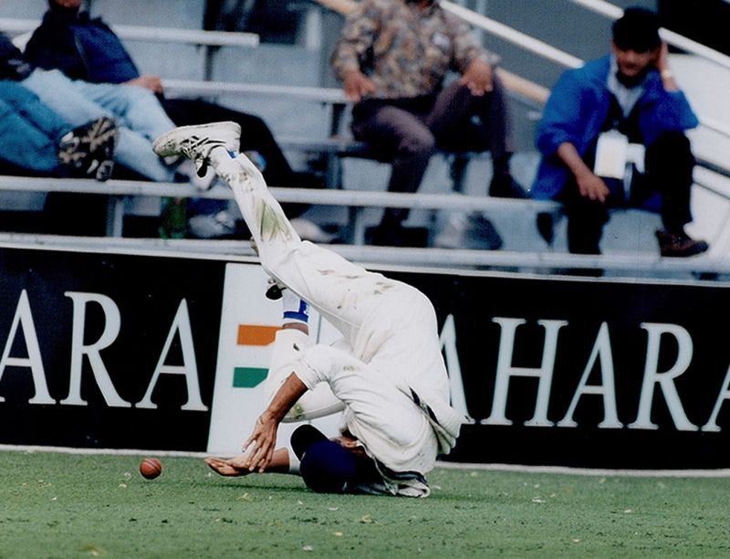 Rahul  Dravid tumbles as he fields near the boundary