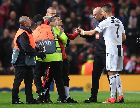 Ronaldo with one of the pitch invader