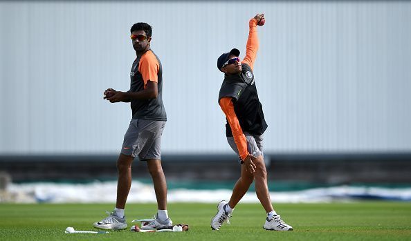 Kuldeep Yadav bowls during a Net session while Ashwin watches on