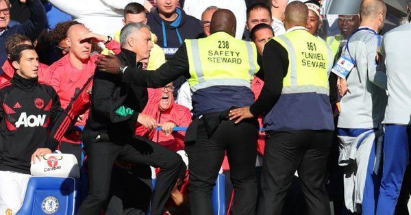 Furious Mourinho being calmed down