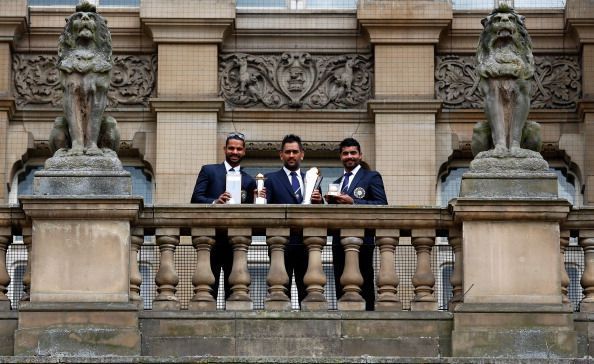 Dhoni with Shikar Dhawan (left) and Ravindra Jadeja (right), India's two biggest match-winners in the Champions Trophy 2013