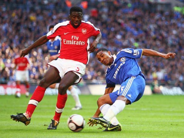 Florent Malouda of Chelsea is closed down by Kolo Toure of Arsenal