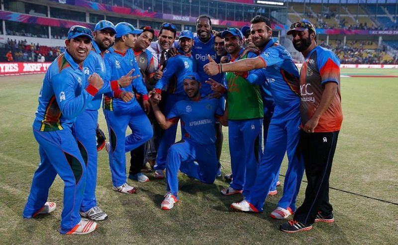 The Afghanistan team with Chris Gayle after defeating the West Indies in the 2016 ICC T20 World Cup