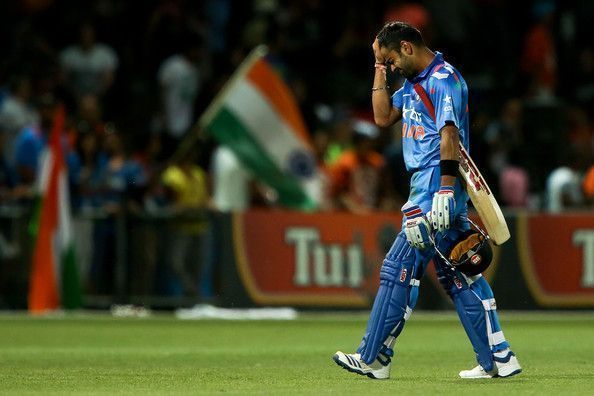 Kohli walks back after scoring a century against New Zealand in 2014