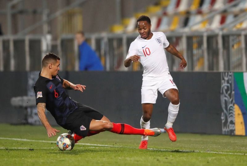 Raheem Sterling and Dejan Lovren vying for the ball