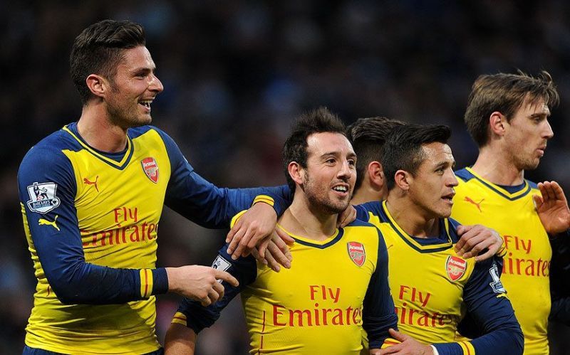 Santi Cazorla celebrates with teammates after scoring against Manchester City