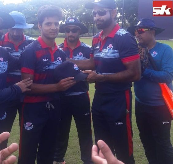 Rasikh Salam getting his debut cap from Irfan Pathan