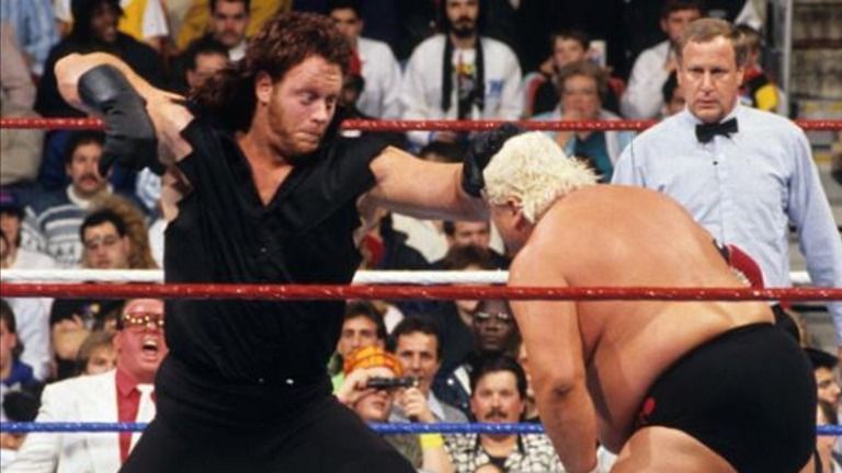 Undertaker punching the lights out of Dusty Rhodes.