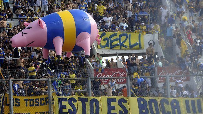 A flying pig in front of the away fans.