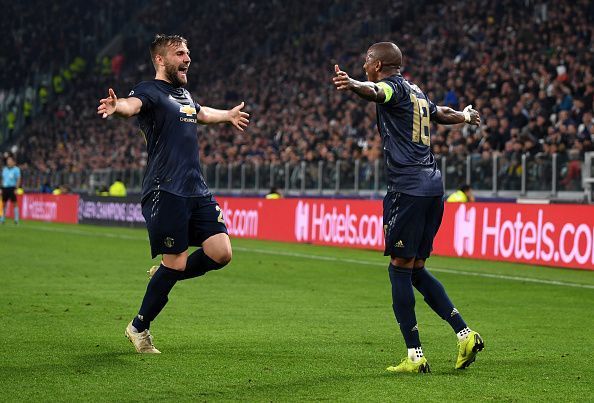 Shaw celebrates one of United&#039;s two goals with defensive counterpart Ashley Young in Turin