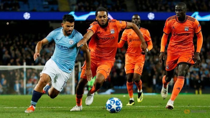 Aguero fights for the ball against Lyon centre-back Jason Denayer