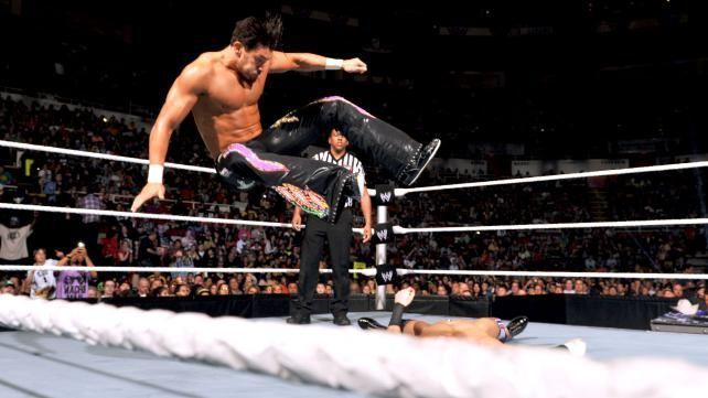 Fandango performs a guillotine leg drop from the top rope.