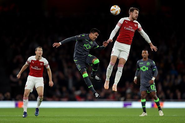Aaron Ramsey tussling for possession in the air during Arsenal&#039;s Group E home clash against Sporting