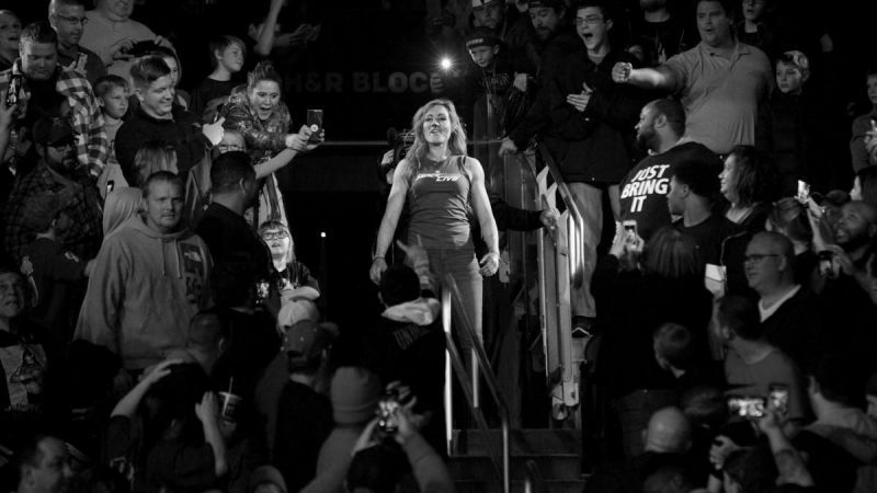 Becky Lynch standing amidst the WWE Universe