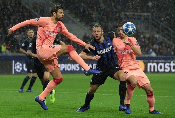 Gerard Pique clears the ball