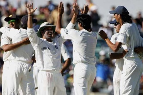 Indian players celebrate after defeating Australia in the 3rd test match at Perth.