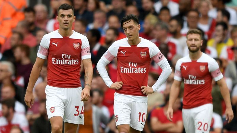 Granit Xhaka, Mesut Ozil and Shkodran Mustafi express worried looks.