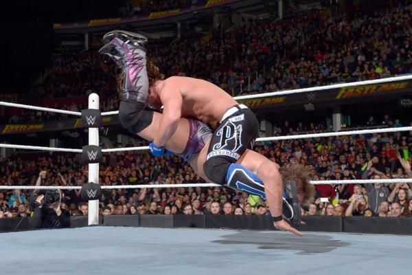 AJ Styles drives his opponent into the mat with the Styles Clash.