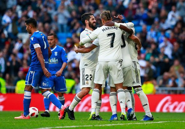 Asensio huddled by his teammates after scoring his second goal of the night