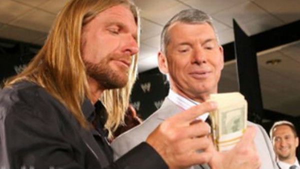 Triple H with hair and Vince McMahon going over business.