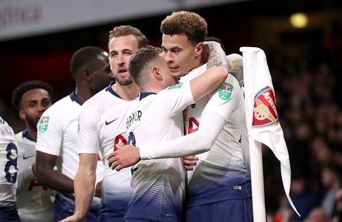 Alli celebrates his deft finish with Spurs teammates during their 2-0 quarter-final win