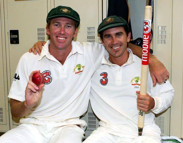 Glenn McGrath posing with the match ball along with the Man of the Match Justin Langer