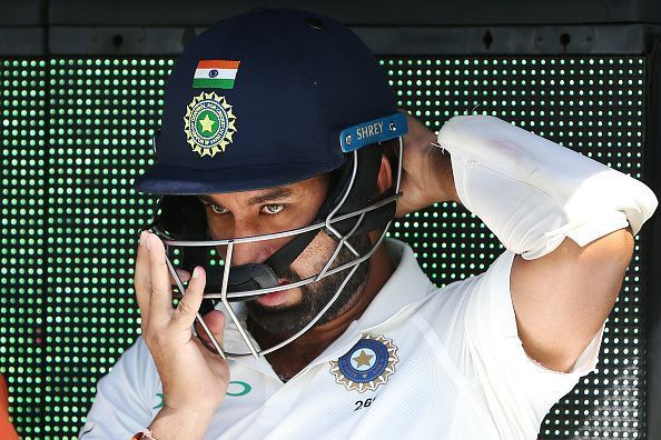 Pujara readies himself to bat.