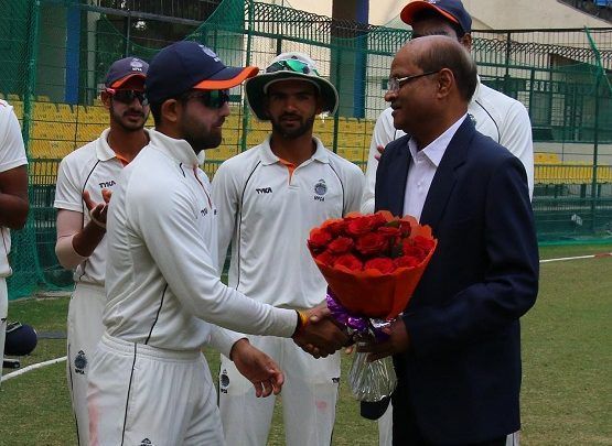 Ajay Rohera receiving the bouquet after his grand knock