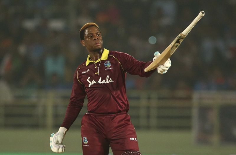 Hetmyer raises his bat after hitting a ton against India