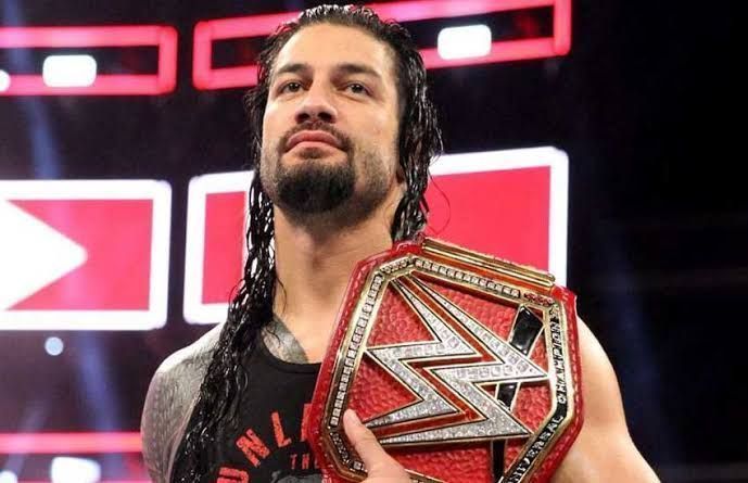Roman Reigns with the WWE Universal title on his shoulder.