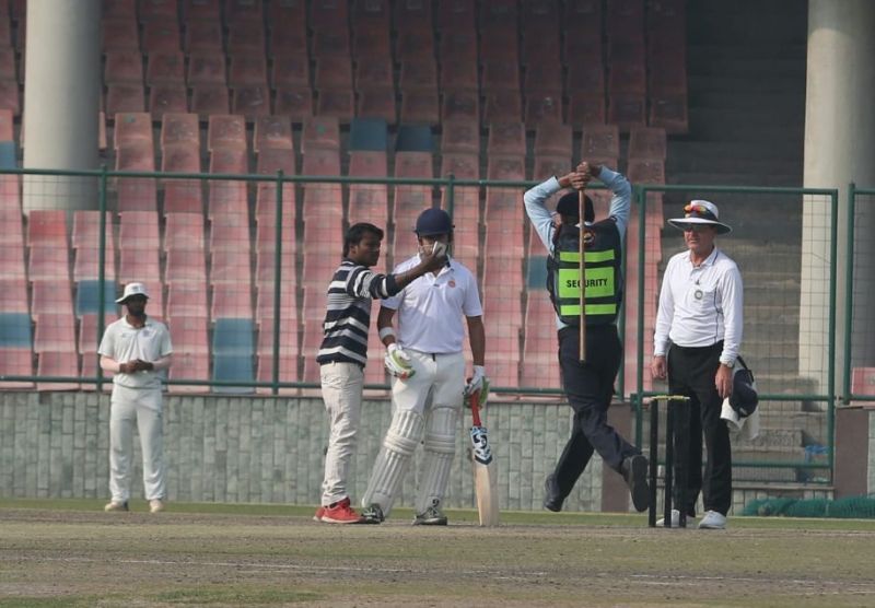 The incoming lathi doesn&#039;t seem to be bothering this socially adept fanatic (Picture credits: Express Photo)