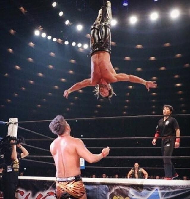 Kenny Omega hits an Asai moonsault on a hapless Kazuchika Okada during their 2nd encounter