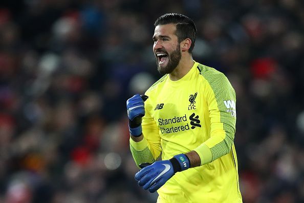 Alisson celebrates a goal against Manchester United at Anfield