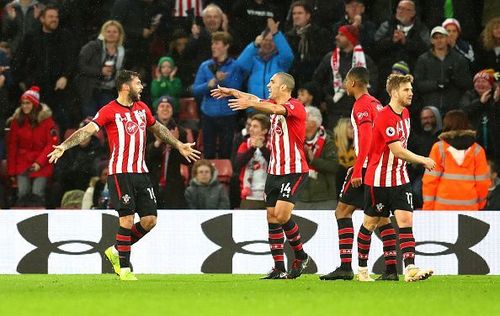 Charlie Austin (far left) celebrates his late winner to sink Arsenal